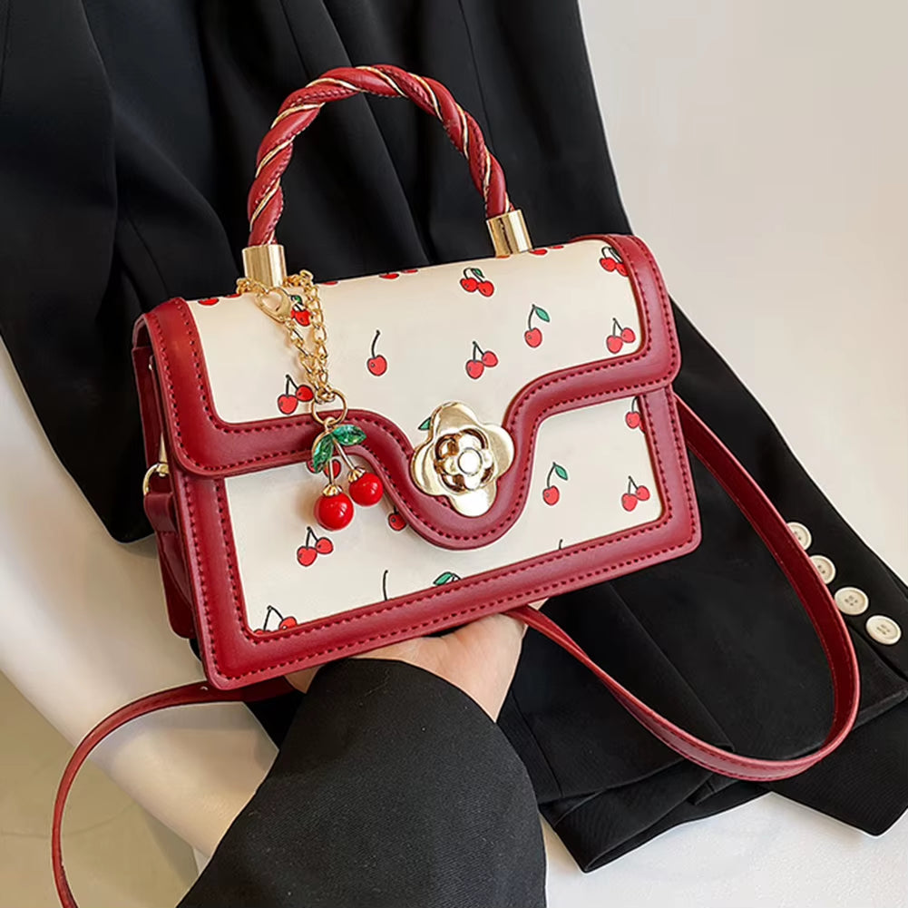 cherry blossom handbag | twist handle shoulder bag | floral handbag for women | elegant women’s purse | cherry blossom purse | stylish shoulder bag | floral fashion bag | women’s casual handbag | trendy floral purse | blossom print bag | spring fashion handbag | cute twist handle bag | feminine shoulder bag