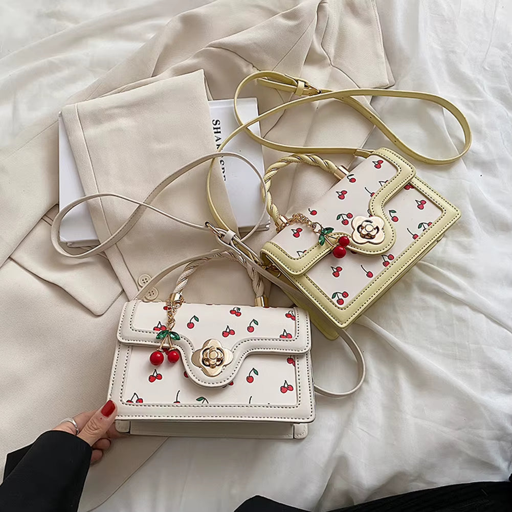 cherry blossom handbag | twist handle shoulder bag | floral handbag for women | elegant women’s purse | cherry blossom purse | stylish shoulder bag | floral fashion bag | women’s casual handbag | trendy floral purse | blossom print bag | spring fashion handbag | cute twist handle bag | feminine shoulder bag